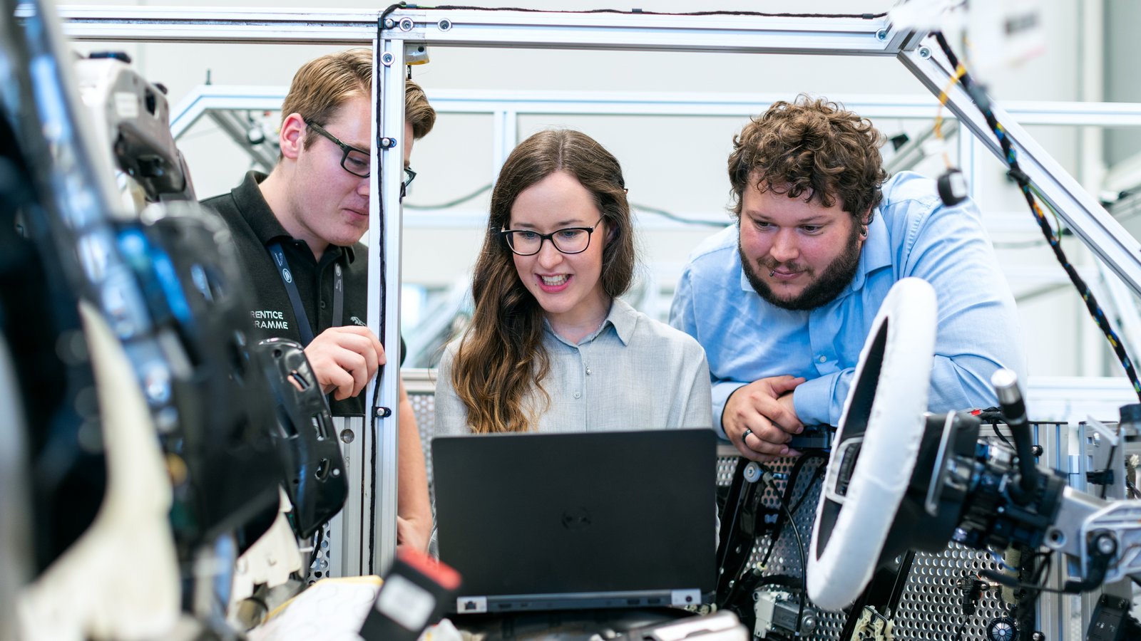 Master building technology students work on automotive vehicle.