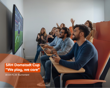 Group players are sitting in a room playing EA FC 25 on a console while watching a soccer game on a big screen.
