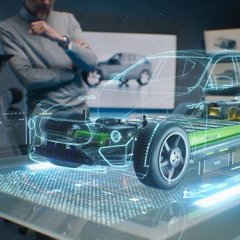 Ein holografisches Modell eines Autos auf einem Tisch, umgeben von Personen, die das Design und die Technik diskutieren.