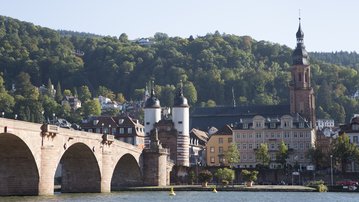 The Old Bridge in Heidelberg with the city in the background and Heidelberg Castle on the hill.